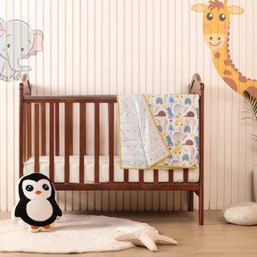 A wooden baby crib with a Premium Baby & Adult Dohar Combo Set draped over the side stands against a striped wall with cartoon animal murals. A stuffed penguin toy and star-shaped cushion are on a soft white rug in front.